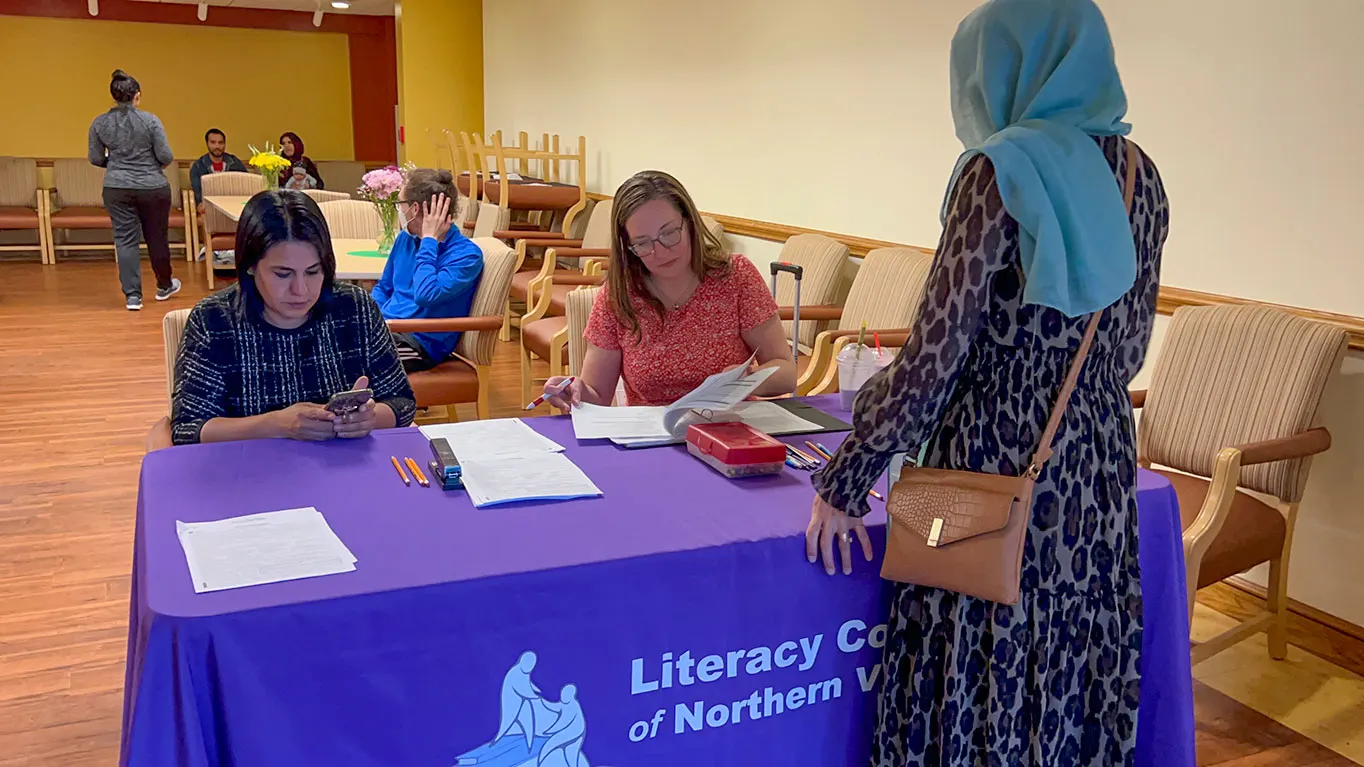 Refugee Submitting Enrollment Form For The English Classes