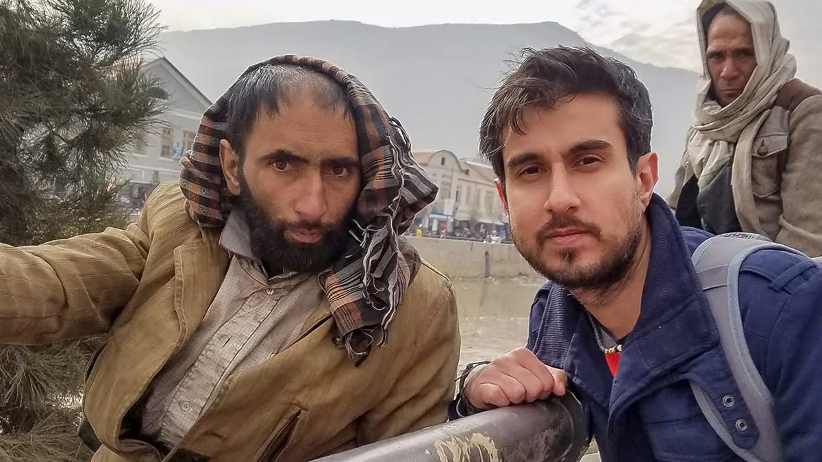 Global Shout founder Ali Karim interviewing a drug addict on a bridge in Kabul
