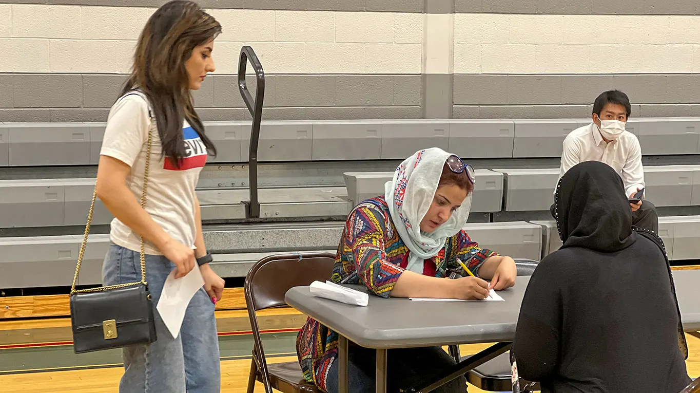 refugee filling enrollment forms for English class