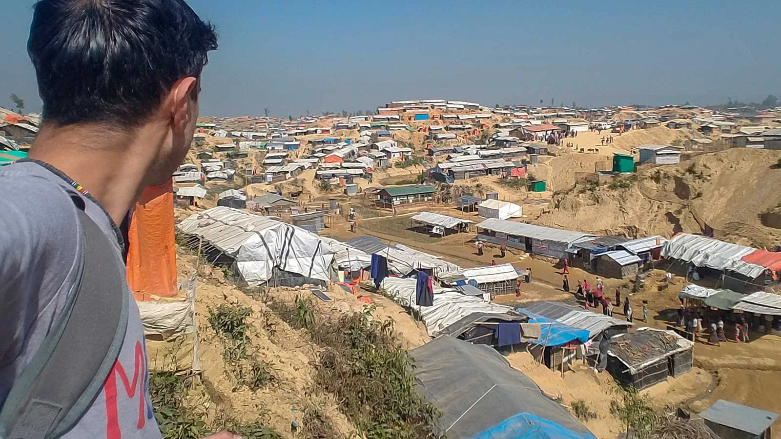 Ali Karim of Global Shout looking over a village