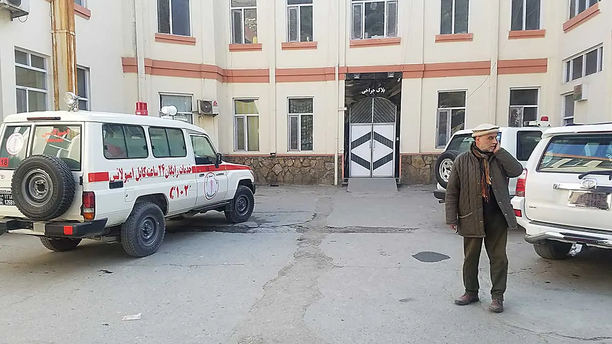 Aliabad hospital with ambulance and a man