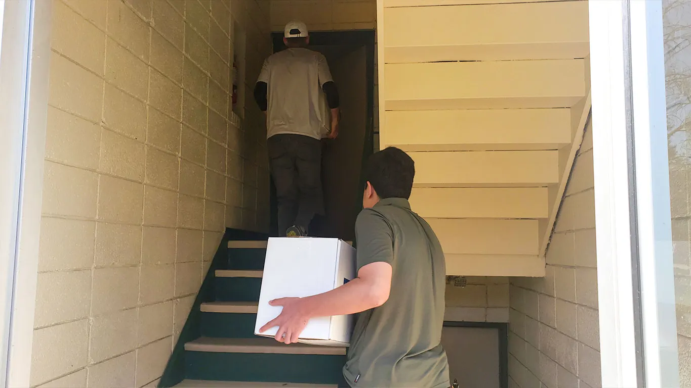 carrying food boxes to Afghans homes